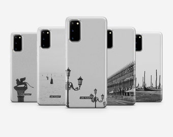 May include: Five clear phone cases with different black and white images of Venice, Italy. The cases feature images of a lion statue, a canal with gondolas, a street lamp, a building, and a gondola. The text "Like Today" appears on each case.