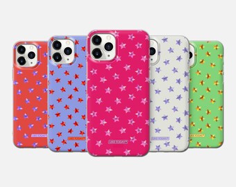 May include: Five different phone cases with a star pattern. The cases are clear and show the phone's color underneath. The star patterns are in red, blue, pink, purple, and green. The cases have the text "Like Today" printed on the bottom.