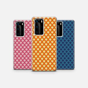 May include: Three phone cases with different geometric patterns. The cases are all clear and show the phone's camera lens. The patterns are pink, orange and yellow, and blue.
