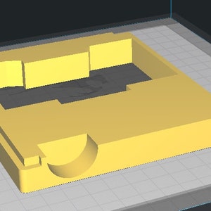 May include: A yellow plastic mold with a rectangular opening and a curved indentation on one side.