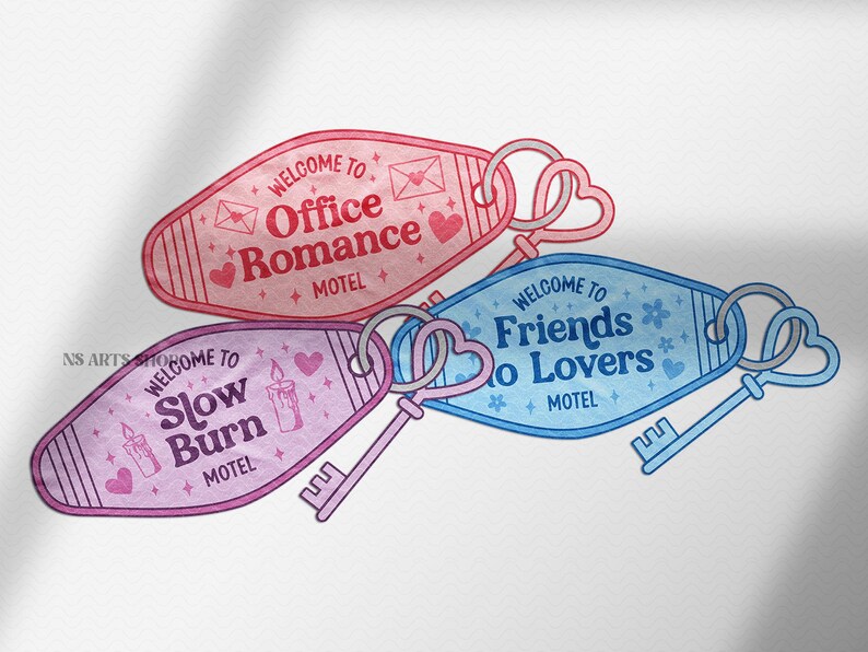 May include: Three motel-style key fobs with heart-shaped key rings. The key fobs are in pink, purple, and blue, each with a different phrase: "Office Romance", "Slow Burn", and "Friends to Lovers". The key fobs have a vintage aesthetic.