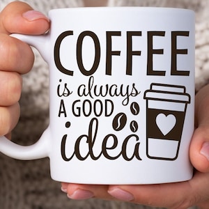 May include: White ceramic coffee mug with black text that reads "Coffee is always a good idea". The mug also features a black and white illustration of a coffee cup with a heart on the side.