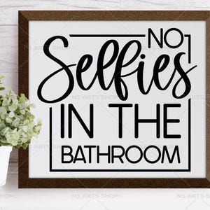 May include: A white framed sign with black text that reads "No. 1 Selfies in the Bathroom".
