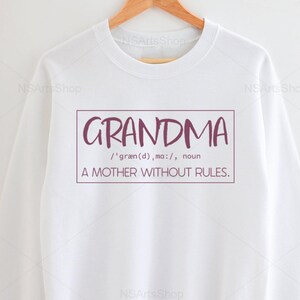 May include: White sweatshirt with a maroon graphic that says "GRANDMA /'gr&aelig;n(d), ma:/, noun A MOTHER WITHOUT RULES."