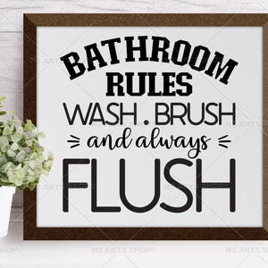 May include: A brown framed sign with white background and black text that reads "Bathroom Rules Wash. Brush = and always = Flush".