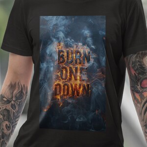 May include: A black t-shirt with a graphic print of the words "BURN ONE DOWN" in a fiery orange font with smoke and flames behind the text.