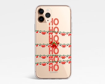 May include: A clear phone case with a gold background and a design of red "HO HO HO" text with Santa hats and green garland. The text "CLASSY" is printed at the bottom of the case.