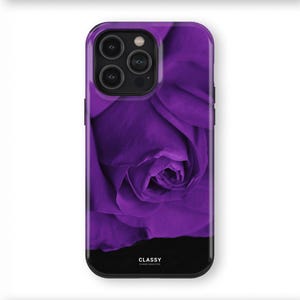 May include: A phone case featuring a close-up of a vibrant purple rose. The case has a black bottom section with the word "CLASSY" printed on it. The phone case is designed to fit a smartphone.