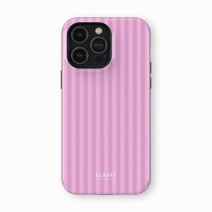 May include: A pink phone case with vertical stripes and the word "CLASSY" printed on the back.