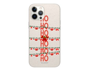 May include: A white phone case with a beige background and a red "HO HO HO" design. The design features a string of Christmas lights with Santa hats hanging from them.