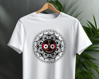May include: White t-shirt with a black and white mandala design featuring a black face with red eyes and a gold crown.