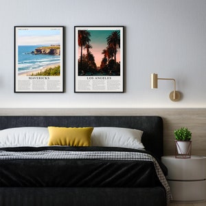 May include: Two framed prints of scenic landscapes. The left print features a beach scene with crashing waves and the text "MAVERICKS". The right print shows a palm tree lined street with the text "LOS ANGELES".