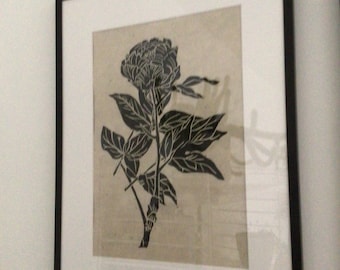 May include: Black and white print of a flower with leaves in a black frame.
