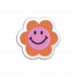 May include: Embroidered flower patch with a smiling face. The flower has orange petals, a pink center with a black smiling face, and a white border. The design is on a white background.