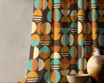 May include: A curtain featuring a repeating geometric pattern of circles and semicircles in shades of teal, mustard yellow, cream, and dark brown. The design includes solid shapes and sections with horizontal stripes arranged on a dark brown background.