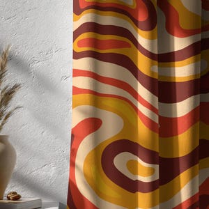 May include: Curtains with a retro design. The fabric features a swirling pattern in shades of orange, yellow, and brown. The design has a textured appearance, adding depth and visual interest. The curtains are hanging, with soft folds visible.