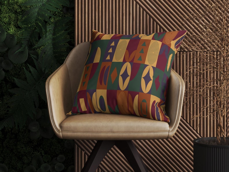 May include: A brown leather chair with a colorful geometric patterned pillow. The pillow has a mix of red, yellow, green, blue, and orange colors.