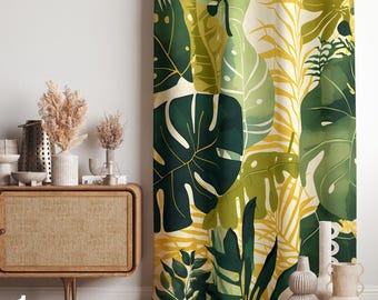May include: A decorative curtain featuring a vibrant tropical leaf pattern in shades of green, yellow, and black against a cream background. The design includes large monstera leaves and other tropical foliage. The curtain is displayed next to a wooden cabinet with decorative vases.