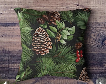 May include: A black throw pillow with a green, brown, and red pine cone and evergreen pattern.