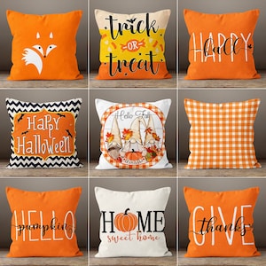 May include: Nine decorative throw pillows with fall and Halloween themes. Pillows feature orange, white, and black colors. Designs include a fox, the words "Trick or Treat", "Happy Fall", "Happy Halloween", gnomes, a gingham pattern, a pumpkin, and the words "Home Sweet Home" and "Give Thanks".