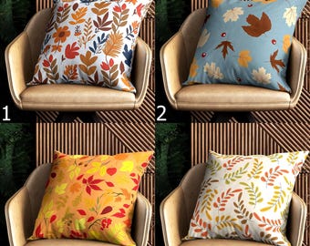 Può includere: Quattro cuscini decorativi con disegni a tema autunnale. I cuscini presentano motivi floreali e di foglie nei toni dell'arancione, giallo, marrone e blu. Ogni cuscino è posto su una poltrona beige, con uno sfondo a doghe di legno.