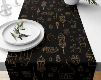 May include: Black and gold table runner with a repeating pattern of Islamic-inspired designs, including lanterns, stars, crescents, and mosques. The runner is perfect for adding a touch of elegance to your Ramadan or Eid celebrations.
