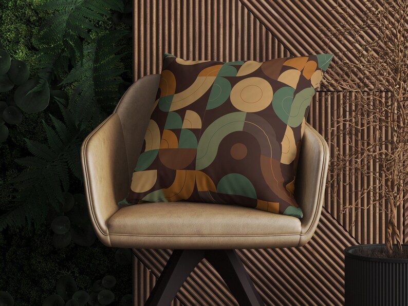 May include: A brown leather chair with a throw pillow featuring a geometric pattern in shades of brown, beige, and green. The pillow has a modern, abstract design.