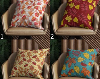 Puede incluir: Cuatro cojines decorativos cuadrados con estampados de hojas otoñales. Los diseños incluyen: blanco con hojas rojas y naranjas, burdeos con hojas amarillas, amarillo con hojas naranjas y turquesa con hojas de otoño y bellotas.