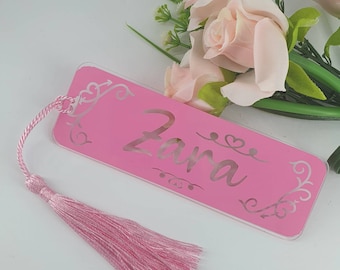 May include: Pink acrylic bookmark with a tassel. The bookmark has the name "Zara" written in a decorative font.