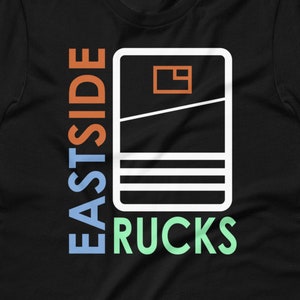 May include: Black t-shirt with a white outline of a cassette tape and the text "Eastside Rucks" in colorful letters.