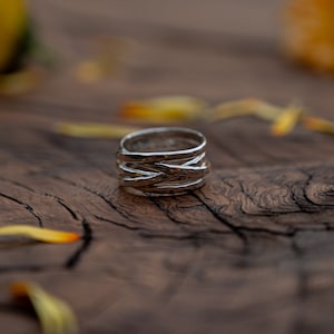 Wide wrap ring in sterling silver with hammered structure by Atelier Linnéa