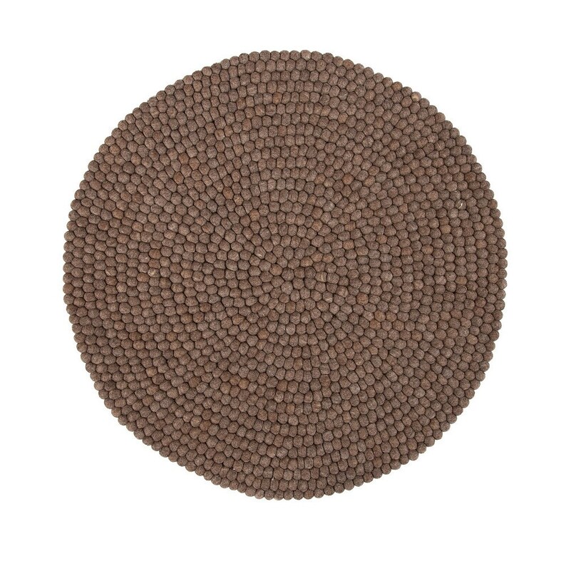 May include: A round brown wool rug made of small balls of felt.
