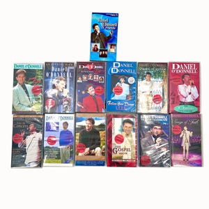 May include: A collection of Daniel O'Donnell VHS tapes. The tapes feature various titles, including "Daniel O'Donnell & Friends," "An Evening With Daniel O'Donnell," and "The Gospel Show." The covers display images of Daniel O'Donnell.