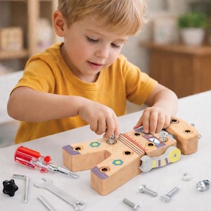 May include: A wooden toy workbench with tools like a screwdriver and spanner. The workbench is light brown with colourful accents. A child is shown assembling the toy. The tools are silver and red.
