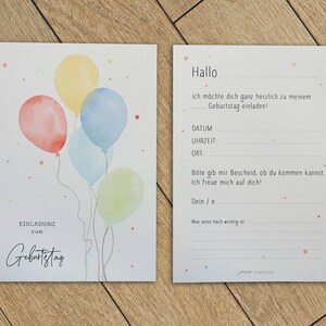 May include: A birthday invitation card with a watercolor illustration of colorful balloons. The card has the text "Einladung zum Geburtstag" which translates to "Invitation to Birthday" in English.