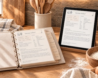 May include: A beige ring-bound recipe binder with tabbed dividers and a tablet displaying the same Gemuse-Auflauf recipe. The binder pages feature printed text in German, including ingredients and instructions for a vegetable casserole dish.