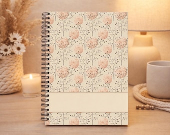 May include: A spiral-bound notebook featuring a repeating pattern of pale pink roses and thin dark brown stems on a cream background. The cover includes a solid, horizontal cream-colored rectangular band across the lower section for personalization.