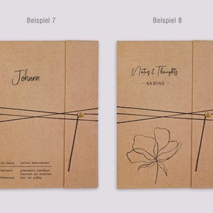 May include: Two rectangular kraft paper folders with black elastic closures and gold fasteners. The left folder features the name Johann and dictionary-style text. The right folder displays the text Notes & Thoughts, SABINE, and a line art flower.