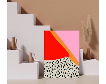 May include: Abstract art print with a red, orange, and pink geometric design on a white background with black polka dots. The print is framed and hanging on a white wall.