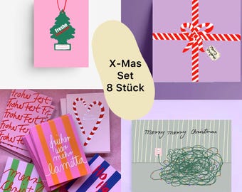 May include: A selection of Christmas cards and gift sets. The image features cards with candy cane hearts, striped designs, and the text "Merry Christmas." A gift box is wrapped with red and white striped ribbon.