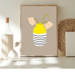 May include: A printable art print featuring a yellow and white striped vase with three light peach flowers. The vase is on a light brown background.
