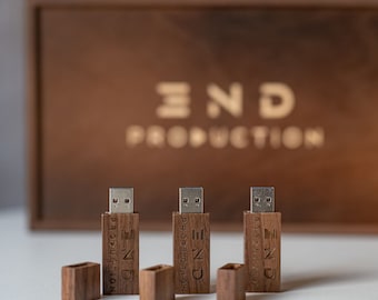 May include: Three wooden USB drives with a silver metal connector. Each drive has the text "END PRODUCTION" engraved on the side.
