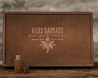 May include: A wooden box containing a USB drive. The box is engraved with the text "Vicky Baumann free spirit weddings" and a stylised design of feathers and an eye.