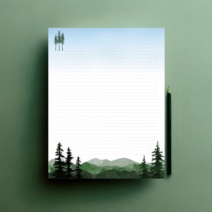 May include: Lined stationery with a watercolor landscape design. The design features a mountain range and evergreen trees in shades of green and black. A pencil rests on the right side of the paper. The top of the paper has a light blue gradient.