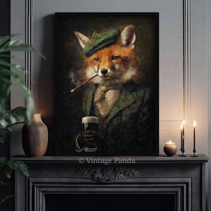 May include: A framed artwork featuring a fox in a green plaid jacket, hat, and ascot, smoking a cigar and holding a pint of beer. The fox has orange and white fur. The artwork is displayed above a fireplace mantel.