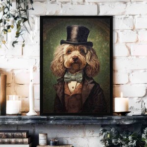 May include: A framed portrait of a dog dressed in formal attire, including a top hat, bow tie, and suit jacket. The dog has curly brown fur and a serious expression. The background is a muted green.