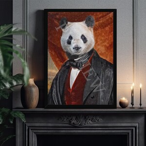 May include: A black framed portrait of a panda wearing a black suit with a red waistcoat and a white bow tie. The background is a red and orange gradient.