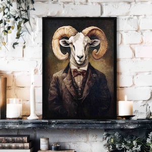 May include: Framed artwork featuring a ram with large, curved horns, dressed in a suit and bow tie. The ram's head is centered, with a dark background and a vintage aesthetic. The artwork is displayed on a mantelpiece with candles and books.