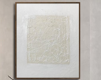 May include: An abstract artwork featuring a textured, cream-coloured square on a white backdrop, framed in dark wood. Two grey, rounded armchairs face each other. A black, round coffee table sits between them, with a vase and decorative branches.
