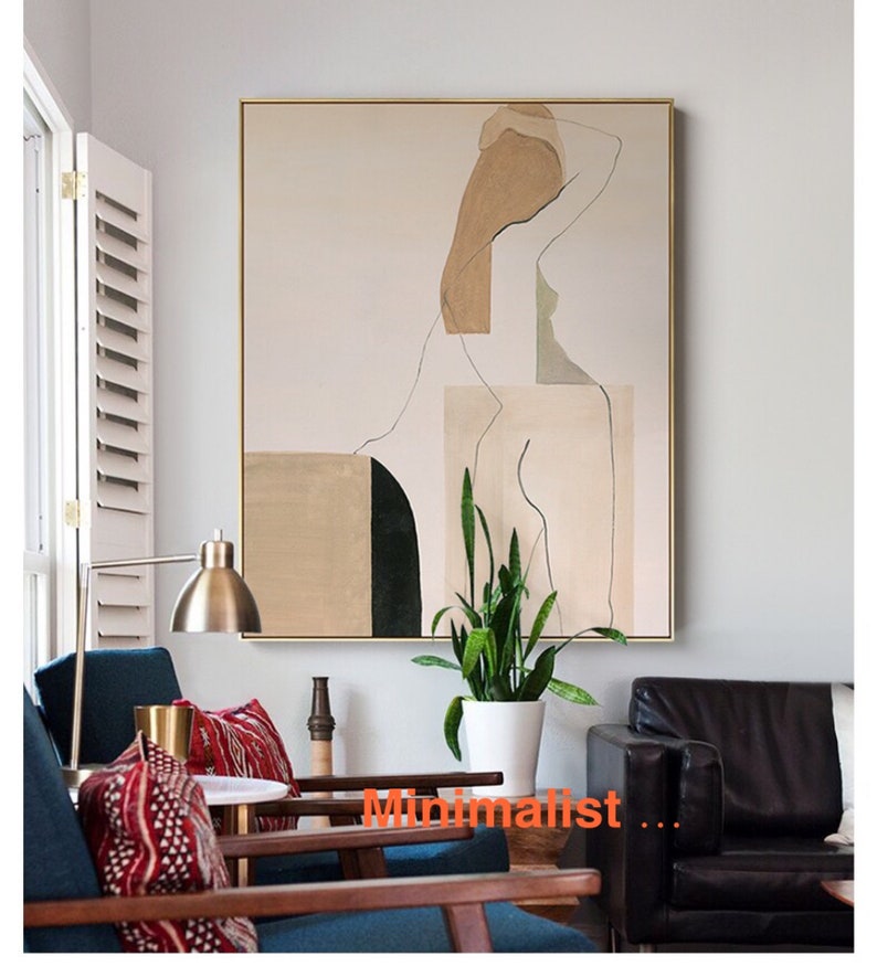 May include: Abstract art print featuring a minimalist line drawing of a person with geometric shapes in beige, green, and black. The print is framed in gold and displayed on a wall in a living room setting.